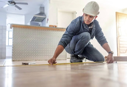 man-carpenter-measure-floor-with-tape-home-interior-buildings